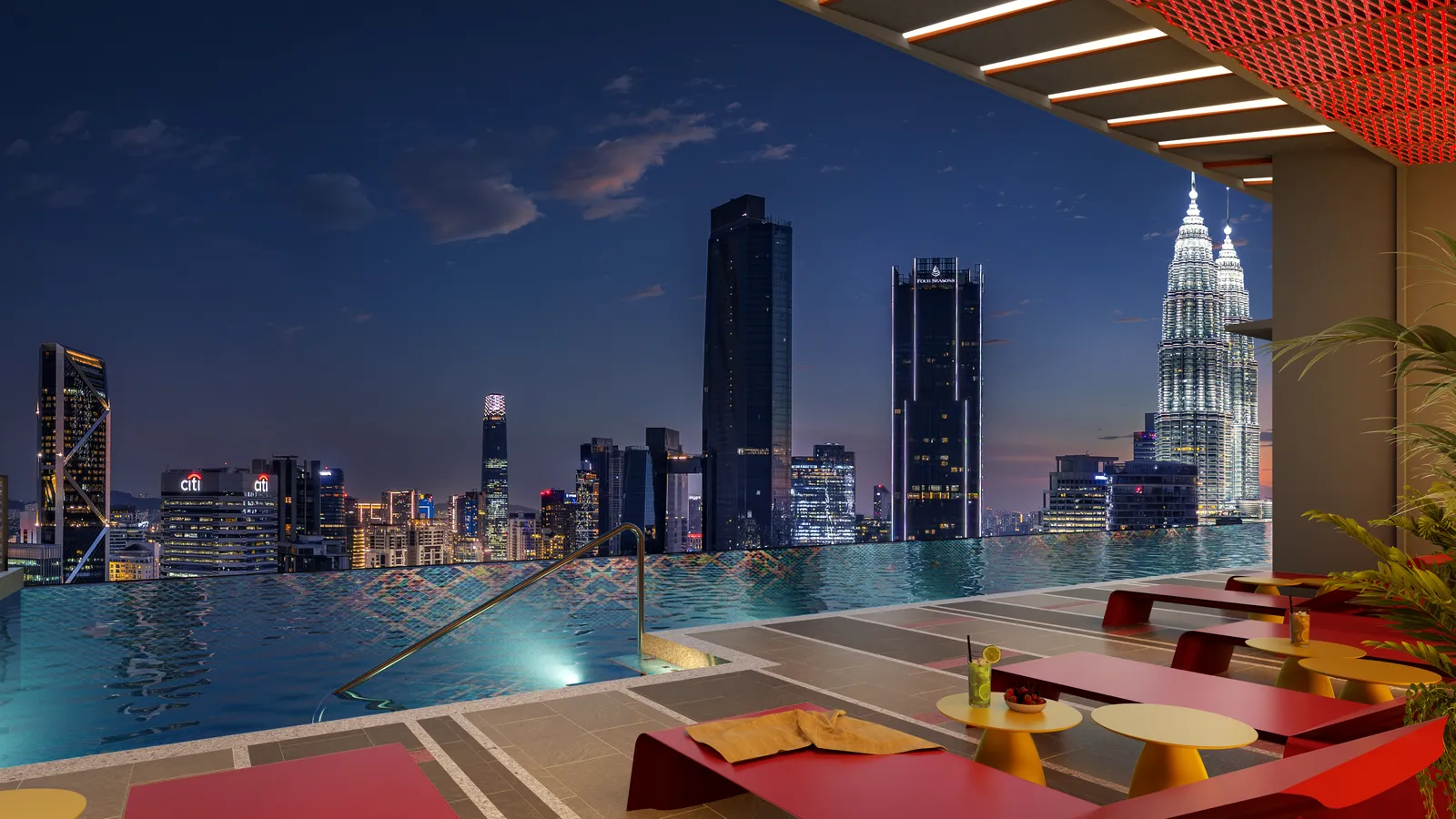 Sky infinity pool at Phoeniz Suites at night, facing the lit Petronas Twin Towers and KL skyline